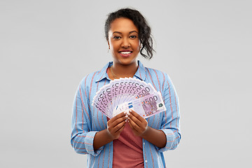 Image showing happy african american woman holding euro money