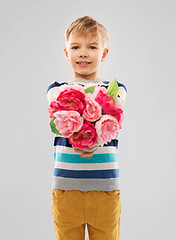 Image showing smiling boy with bunch of peony flowers