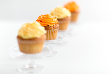 Image showing cupcakes with frosting on confectionery stands