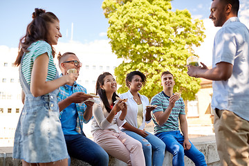 Image showing friends eating sandwiches or burgers in park