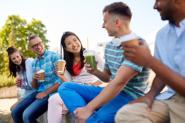 Image showing friends drinking coffee and juice talking in city