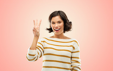 Image showing happy smiling woman showing three fingers