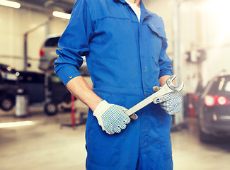 Image showing auto mechanic or smith with wrench at car workshop