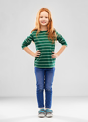 Image showing smiling red haired girl posing in striped shirt