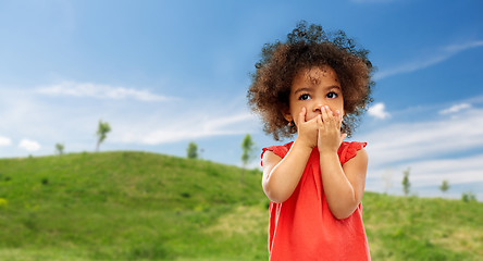 Image showing confused african american girl covering mouth