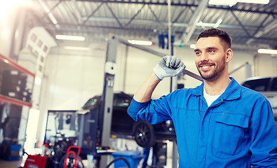 Image showing auto mechanic or smith with wrench at car workshop