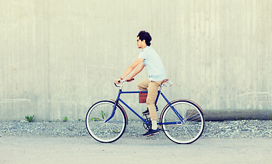 Image showing young hipster man riding fixed gear bike