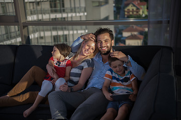 Image showing happy young couple spending time with kids at home