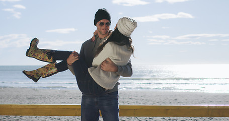 Image showing Couple having fun on beautiful autumn day at beach