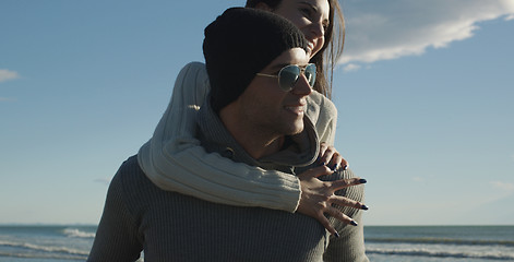 Image showing couple having fun at beach during autumn