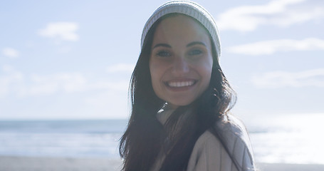 Image showing Girl In Autumn Clothes Smiling on beach