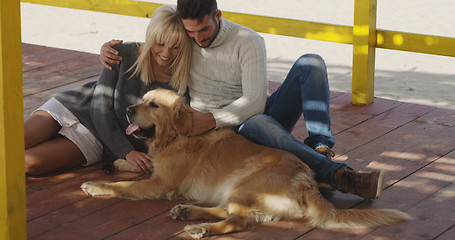 Image showing Couple with dog enjoying time on beach