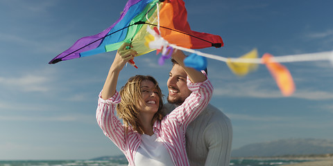 Image showing Happy couple having fun with kite on beach