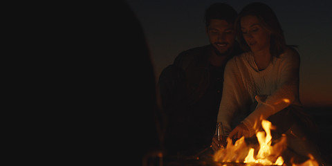 Image showing Couple enjoying with friends at night on the beach