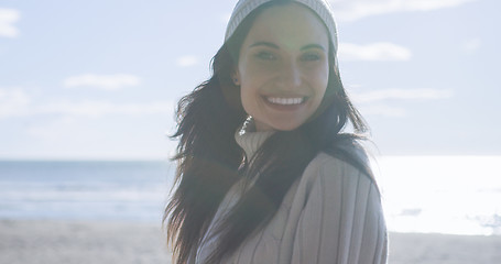 Image showing Girl In Autumn Clothes Smiling on beach