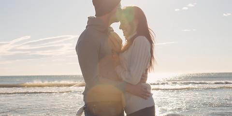 Image showing Couple having fun on beautiful autumn day at beach