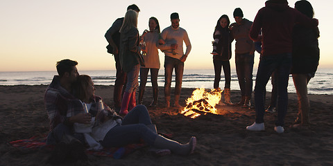 Image showing Friends having fun at beach on autumn day