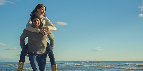 Image showing couple having fun at beach during autumn