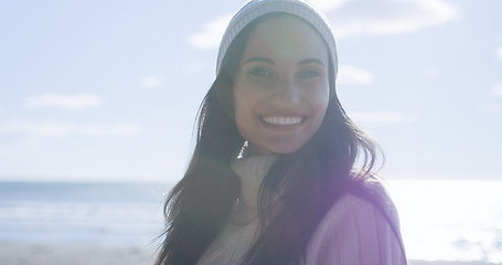 Image showing Girl In Autumn Clothes Smiling on beach