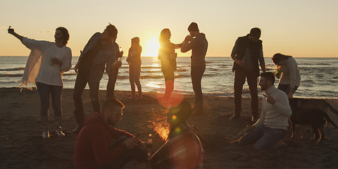 Image showing Friends having fun at beach on autumn day