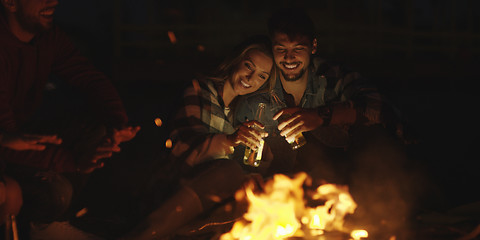 Image showing Couple enjoying with friends at night on the beach