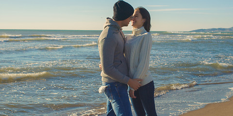 Image showing Couple having fun on beautiful autumn day at beach