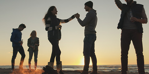 Image showing Friends having fun at beach on autumn day