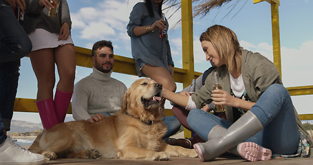 Image showing Group of friends having fun on autumn day at beach