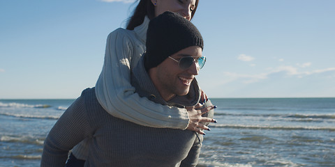 Image showing couple having fun at beach during autumn