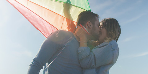 Image showing Happy couple having fun with kite on beach