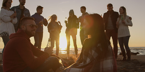 Image showing Friends having fun at beach on autumn day