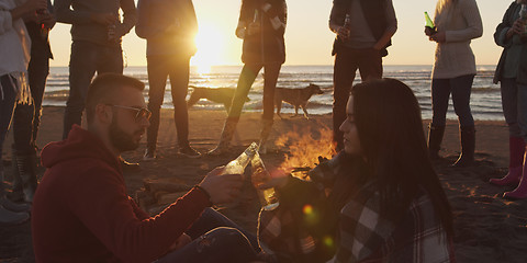 Image showing Friends having fun at beach on autumn day