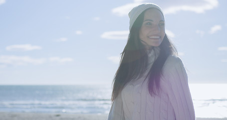 Image showing Girl In Autumn Clothes Smiling on beach