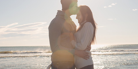 Image showing Couple having fun on beautiful autumn day at beach