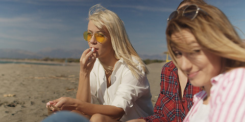 Image showing Group of girlfriends having fun on beach during autumn day