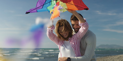 Image showing Happy couple having fun with kite on beach