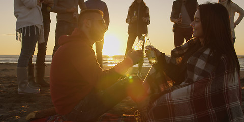 Image showing Friends having fun at beach on autumn day