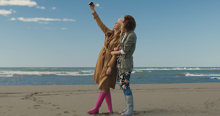 Image showing Girls having time and taking selfie on a beach