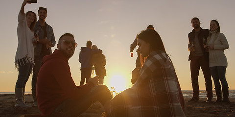 Image showing Friends having fun at beach on autumn day