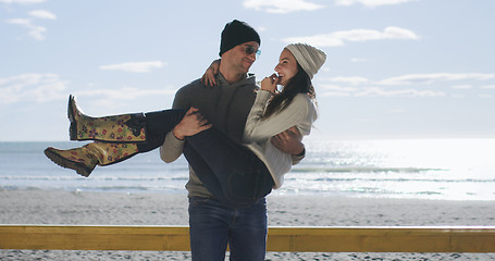 Image showing Couple having fun on beautiful autumn day at beach