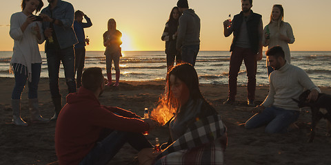 Image showing Friends having fun at beach on autumn day