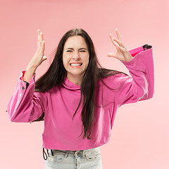 Image showing Beautiful woman looking suprised and bewildered isolated on pink