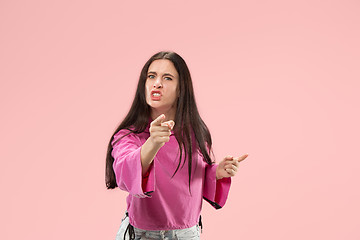 Image showing Portrait of an angry woman looking at camera isolated on a pink background