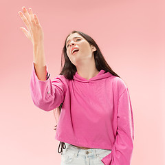 Image showing Beautiful woman looking suprised and bewildered isolated on pink