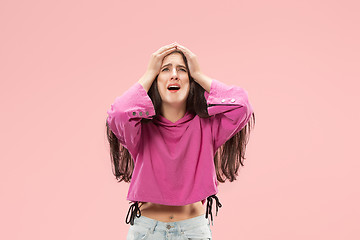 Image showing Beautiful woman looking suprised and bewildered isolated on pink