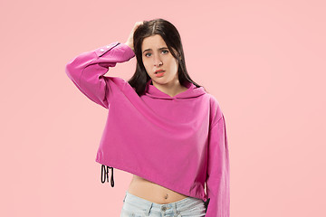 Image showing Beautiful woman looking suprised and bewildered isolated on pink