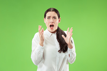 Image showing Portrait of the scared woman on green