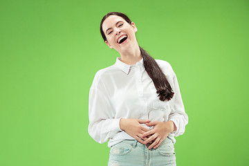 Image showing The happy business woman standing and smiling against green background.