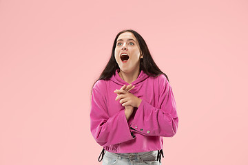 Image showing Beautiful woman looking suprised isolated on pink