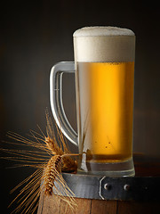 Image showing beer jug on old wooden barrel